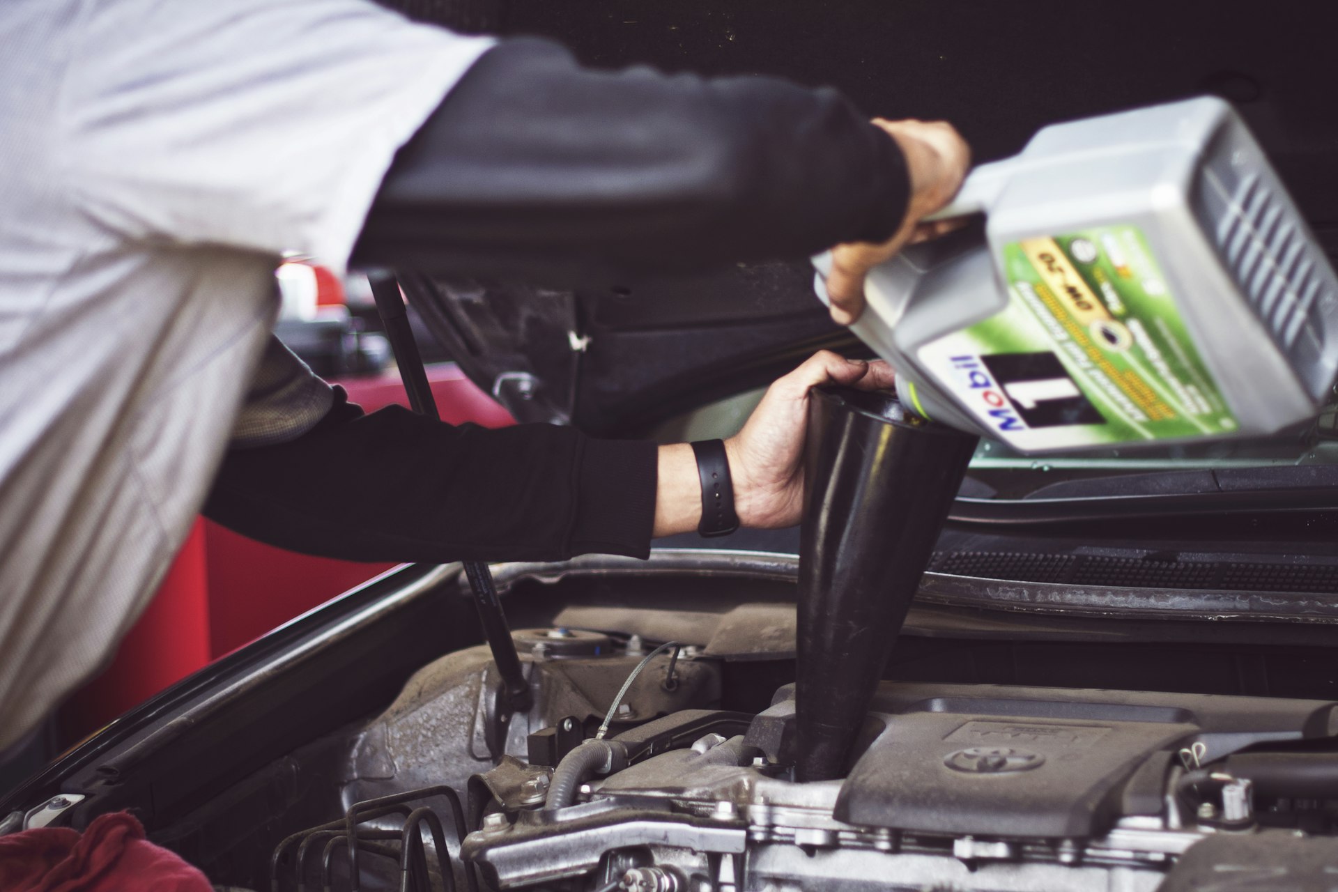 Mechanic working on a car engine in the shop